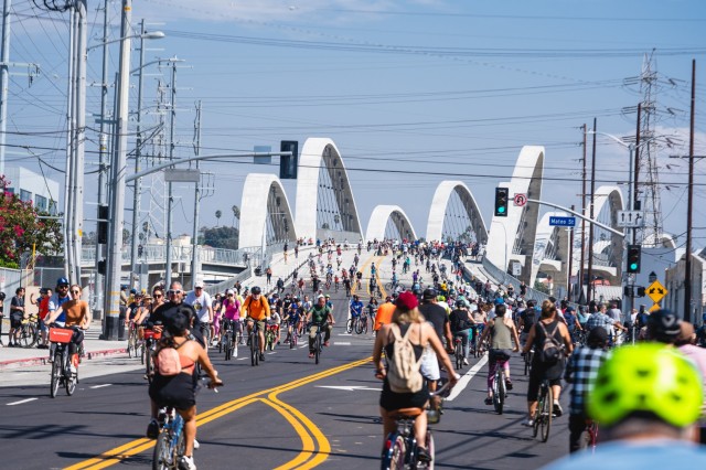 Dozens of cyclists riding across the 6th Street Bridge in L.A.